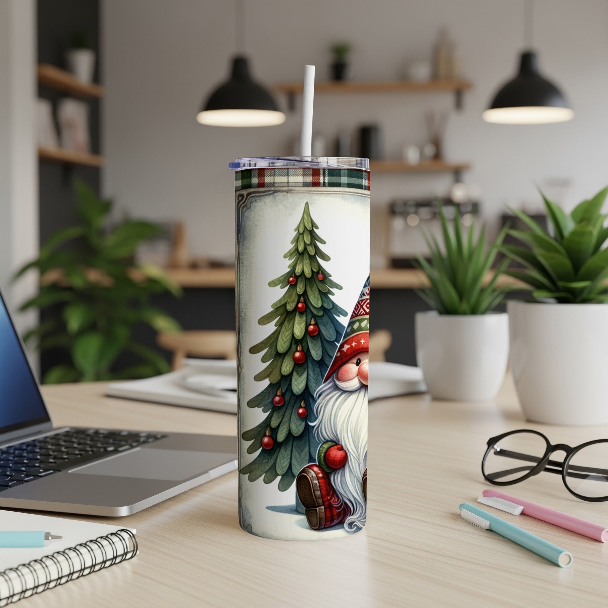 Christmas gnome and tree design on a white tumbler with straw on a desk.
