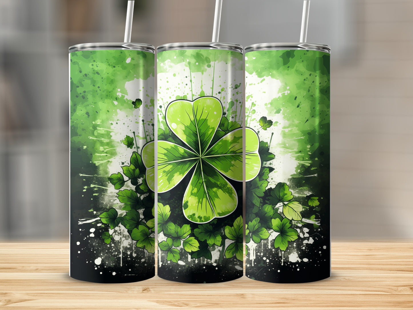 Three tumblers with a green shamrock and watercolor splatter design.