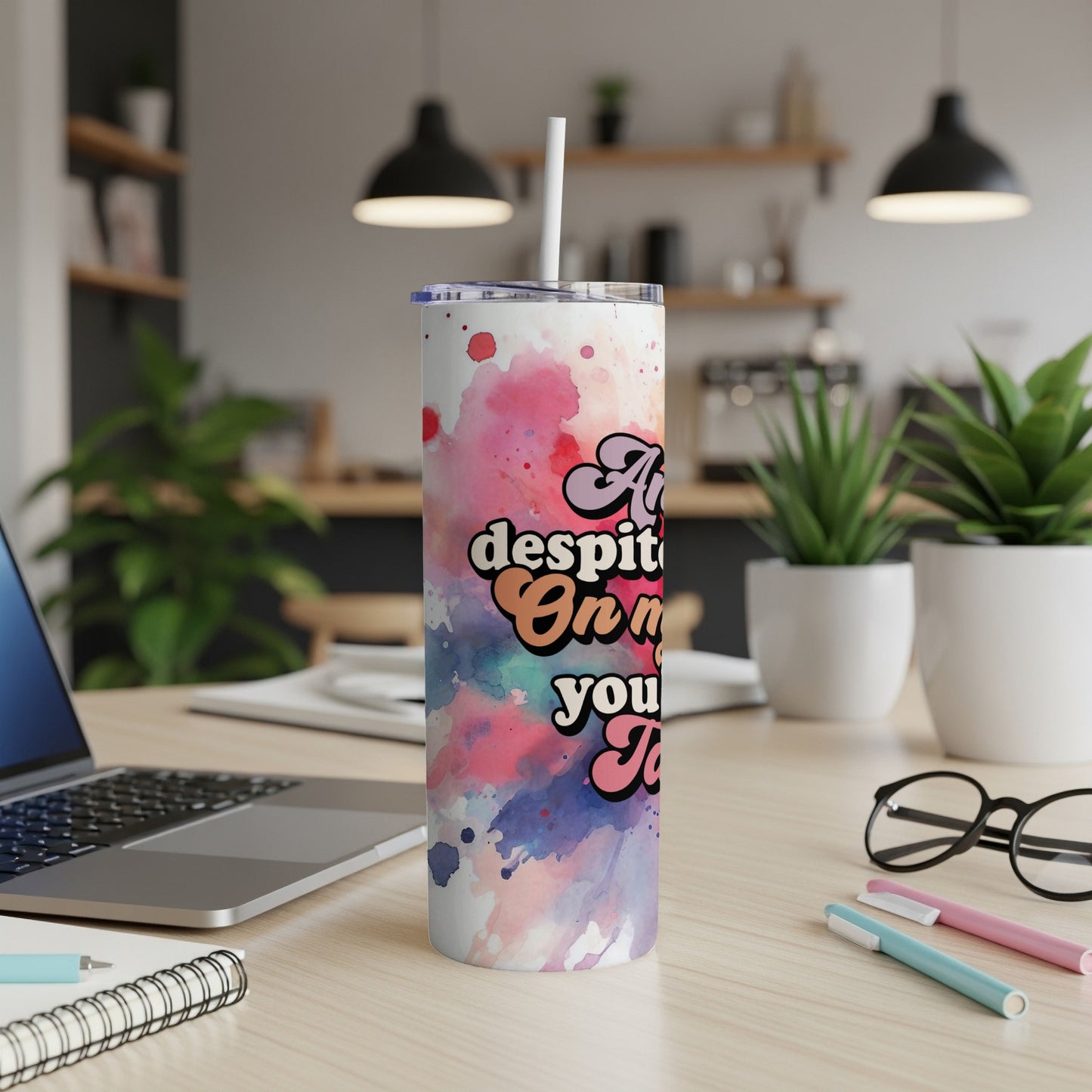 Tall tumbler with colorful watercolor design and text.