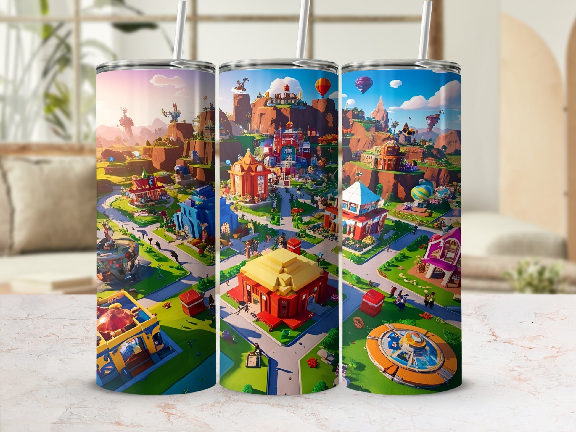 Three tumblers displaying a colorful cartoon village with buildings, trees, and hot air balloons.
