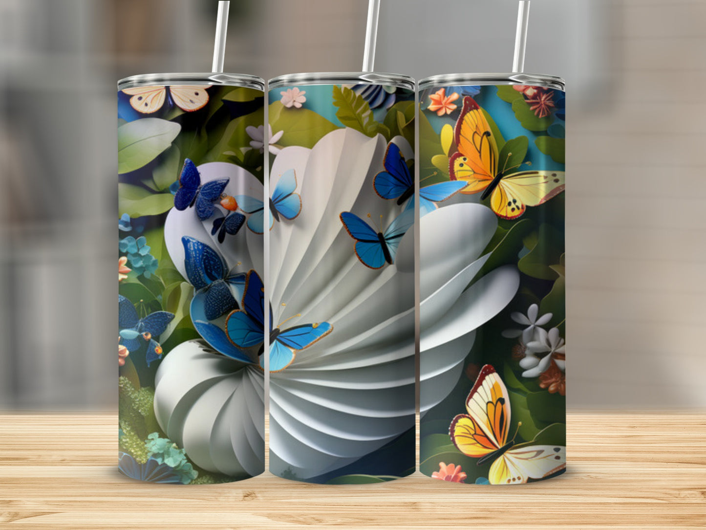 Three tumblers decorated with butterflies and floral patterns.