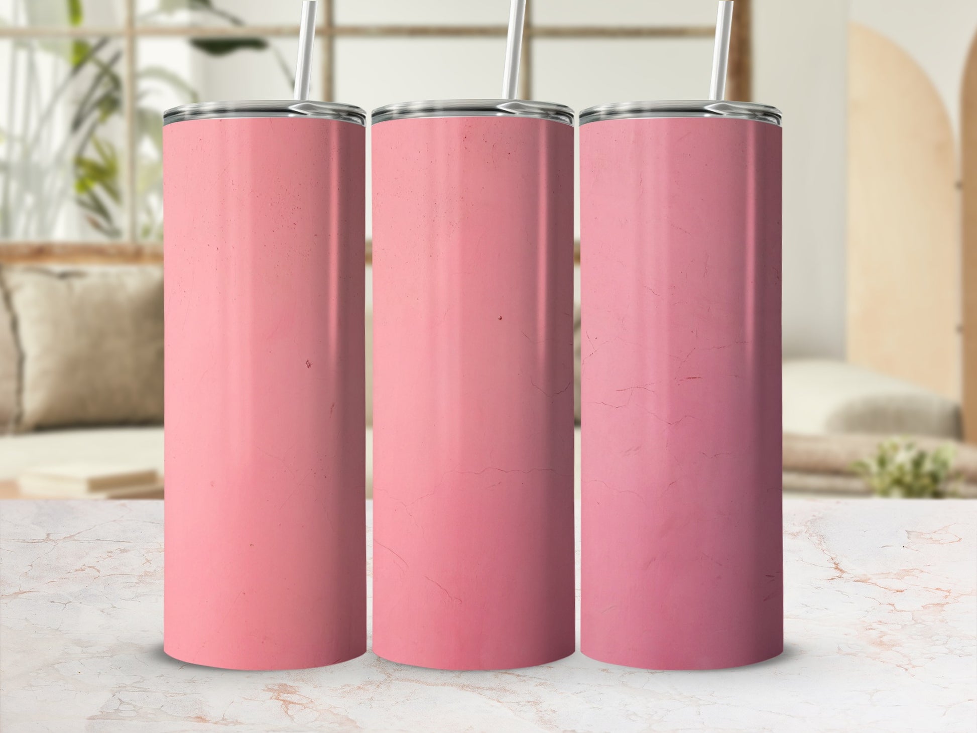 Three pink tumblers with straws arranged in a row.