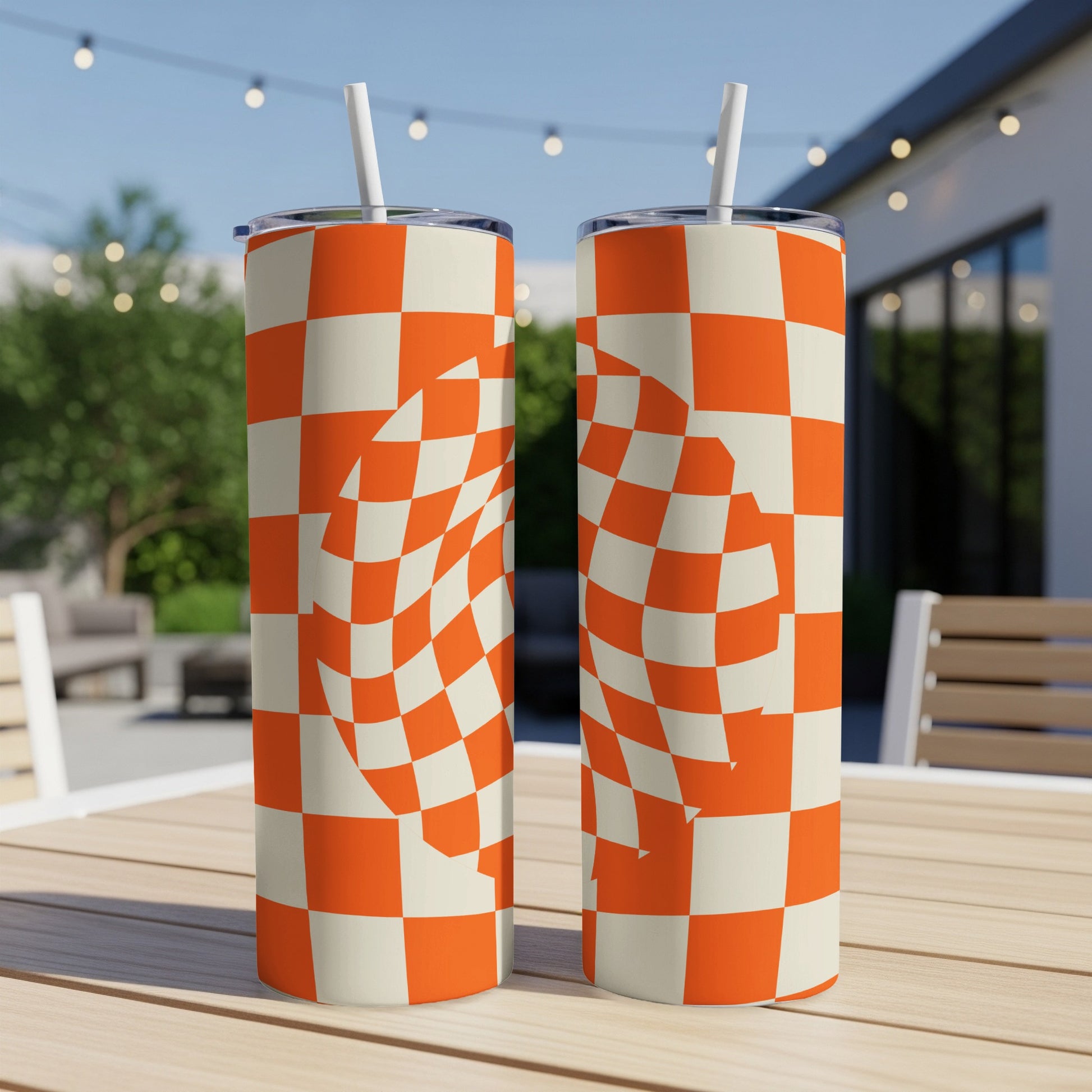 Two tall tumblers with orange and white checkered pattern, one slightly in front of the other.
