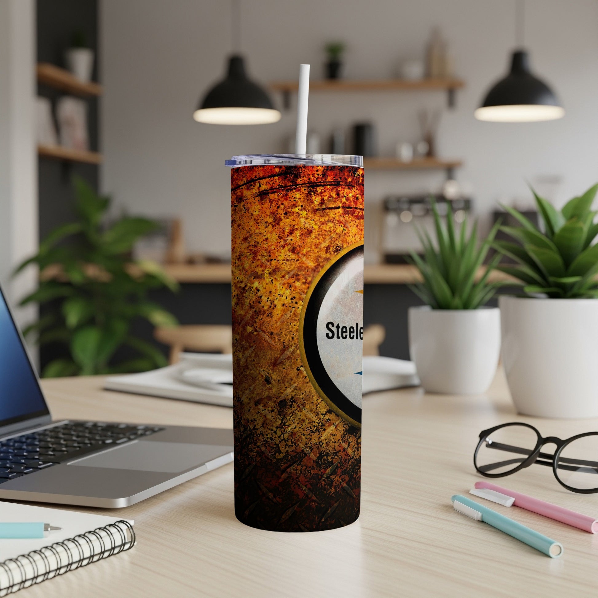 Pittsburgh Steelers tumbler with a distressed texture and logo, featuring a straw.