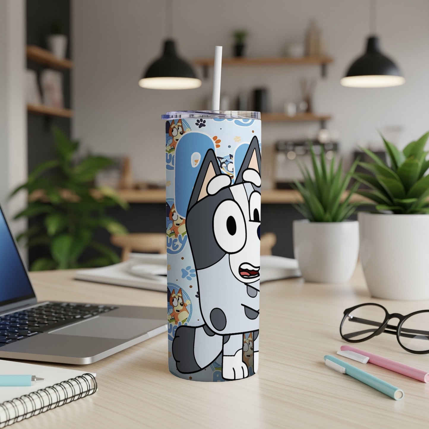 Bluey character tumbler with lid and straw on a desk.