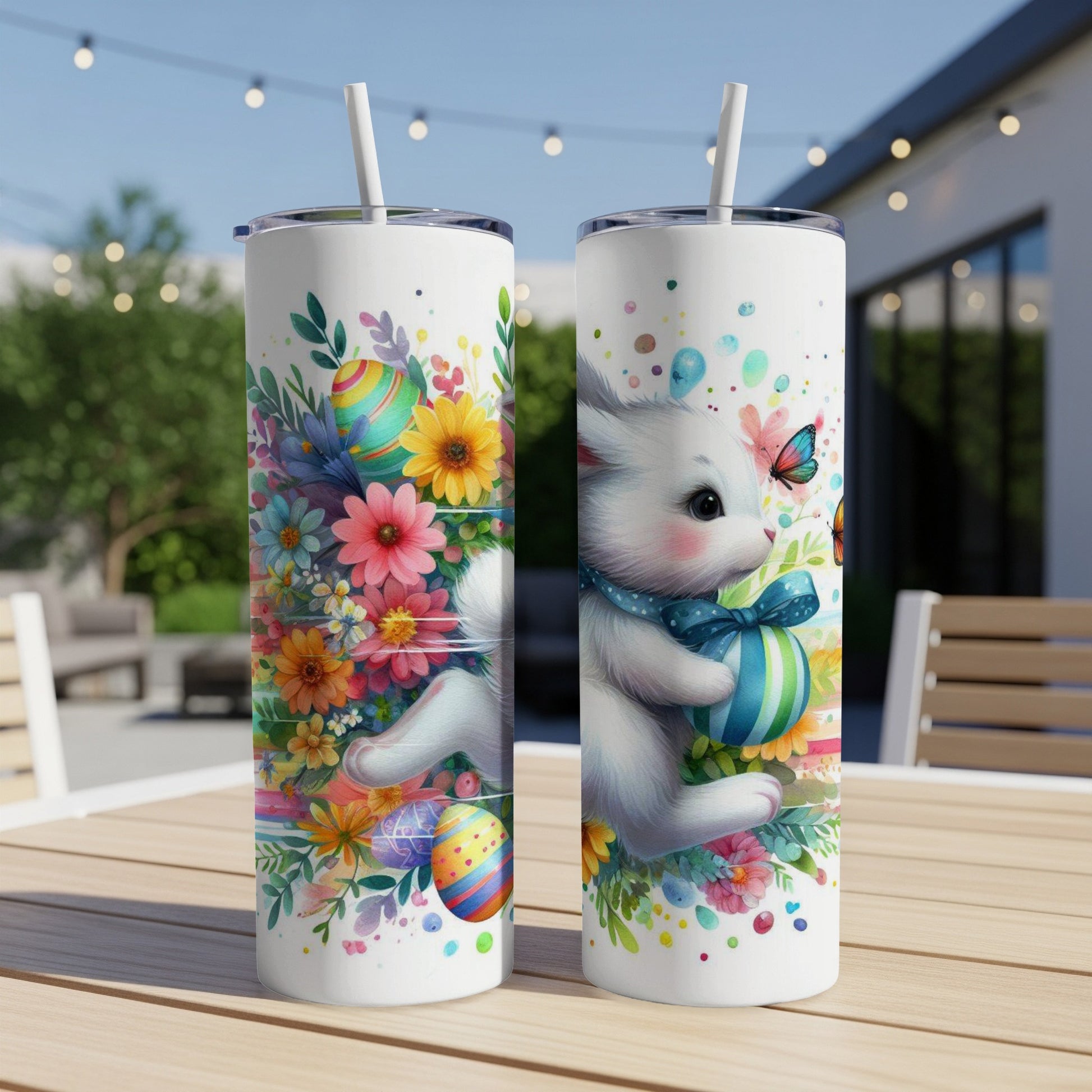 White cat with blue ribbon holding Easter egg, surrounded by flowers and butterflies.