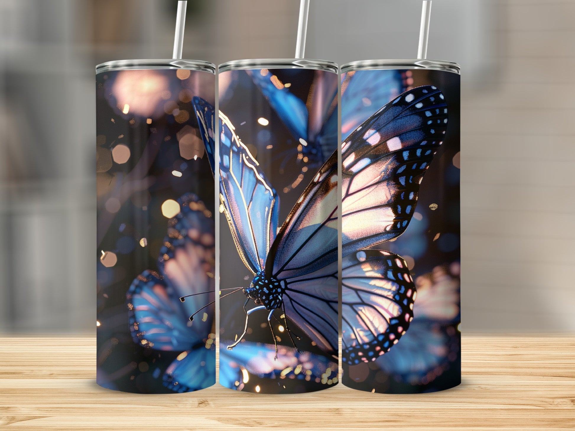 Three tumblers with a close-up blue butterfly design and bokeh background.