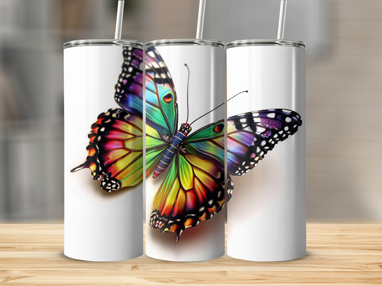 Three white tumblers featuring a vibrant, colorful butterfly design.