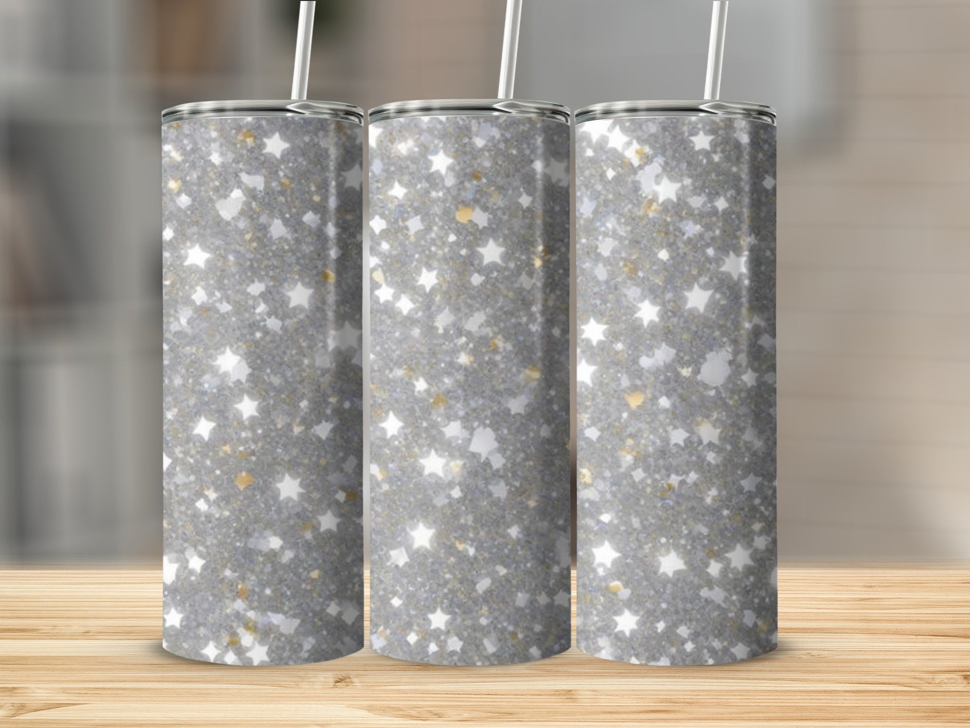 Three tumblers with silver glitter and gold stars pattern.