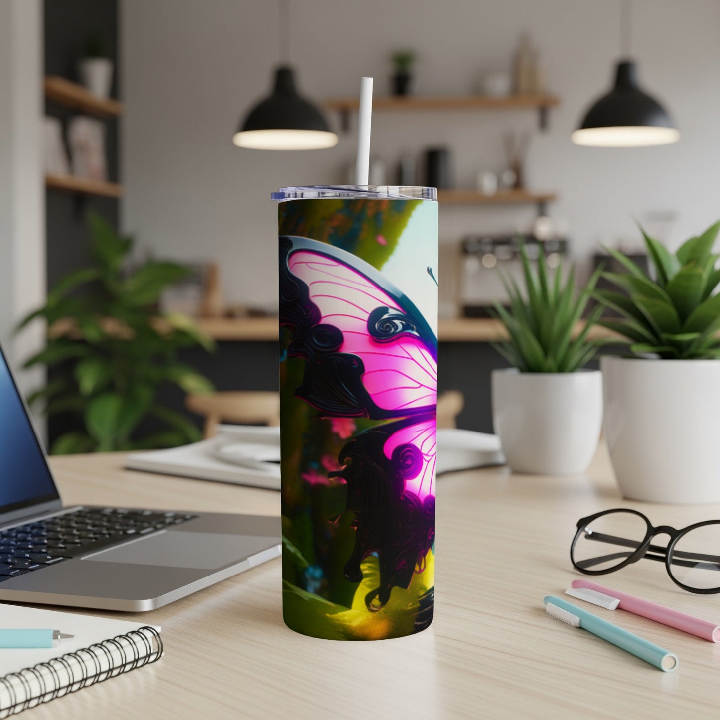 Pink butterfly on a tumbler with a straw on a desk.