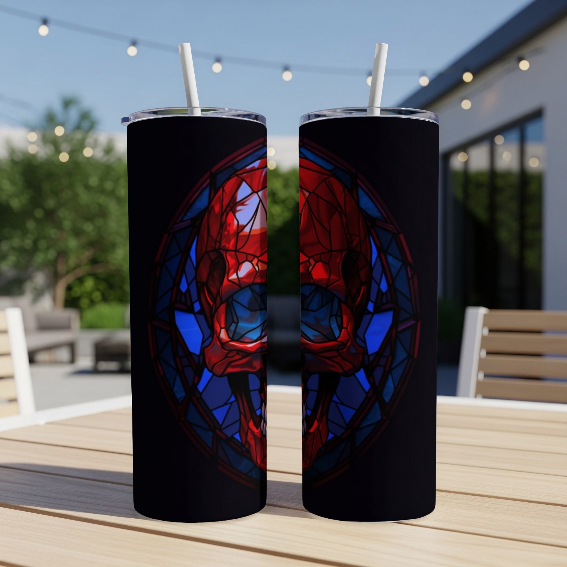 Black tumbler with stained glass snake skull design and straw.