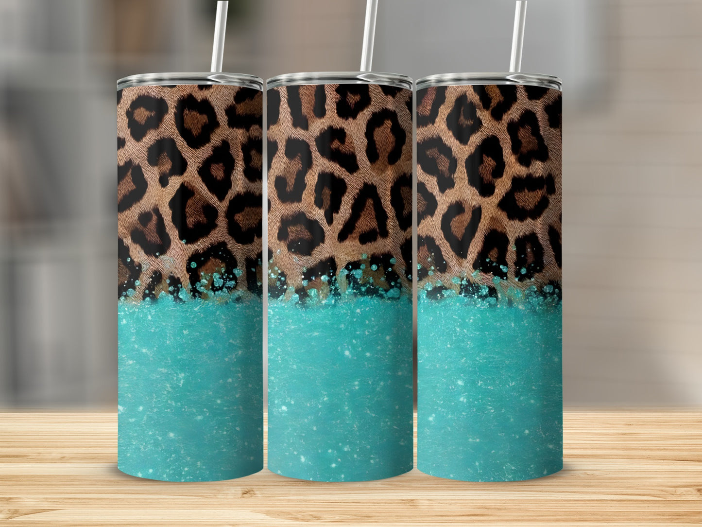 Leopard print tumbler with sparkling turquoise bottom and straw.