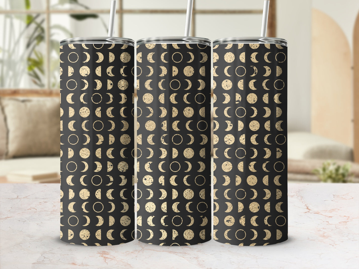 Three tumblers with a black and gold moon phase pattern, each with a white straw.
