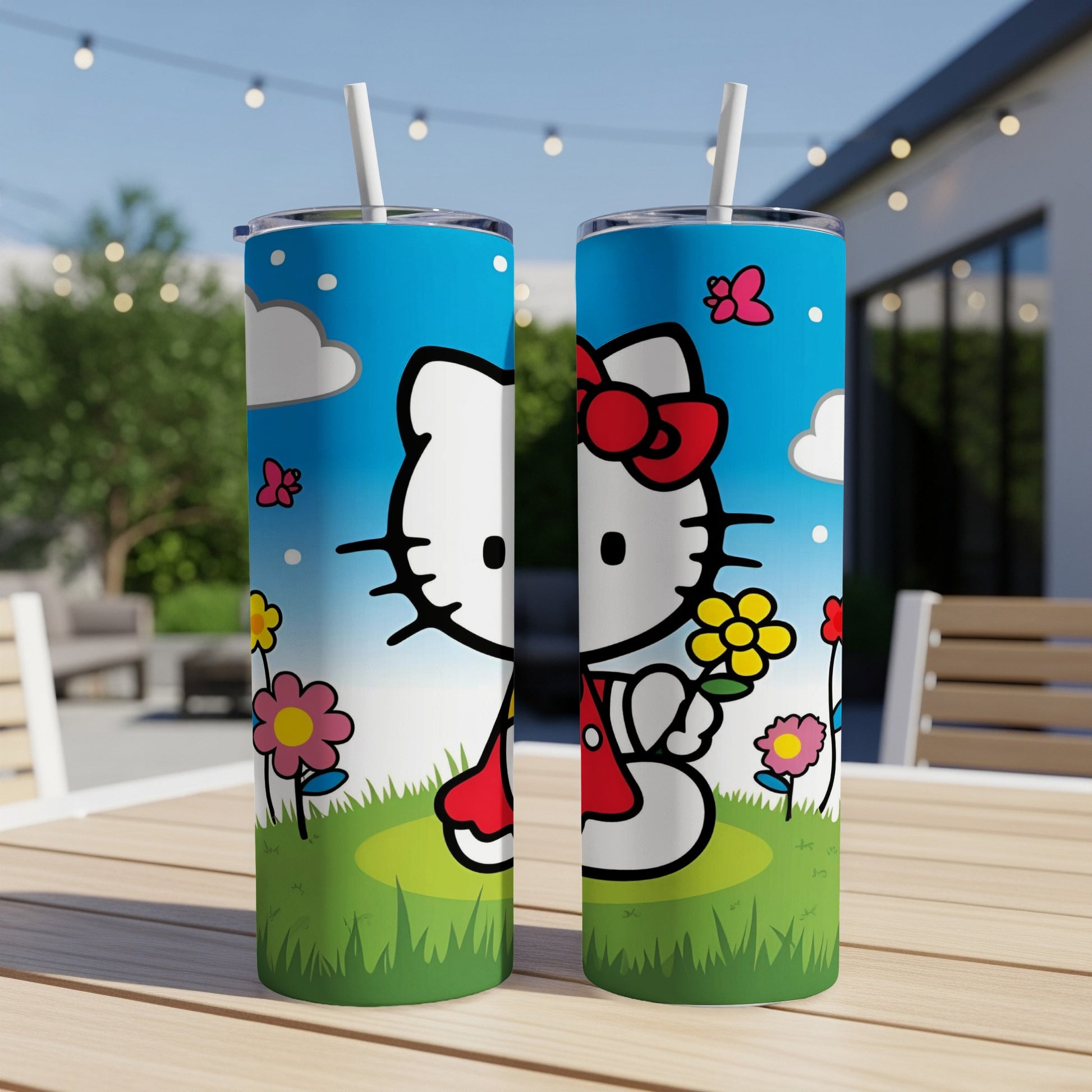 Hello Kitty tumbler with flowers, butterflies, and clouds on a grassy background.