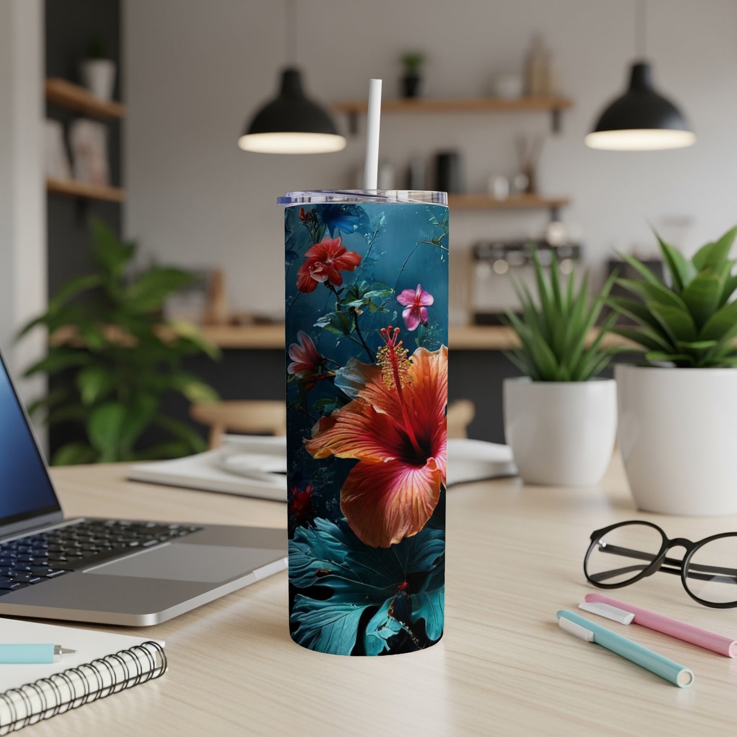 Tall tumbler with a vibrant orange hibiscus flower and dark green leaves.