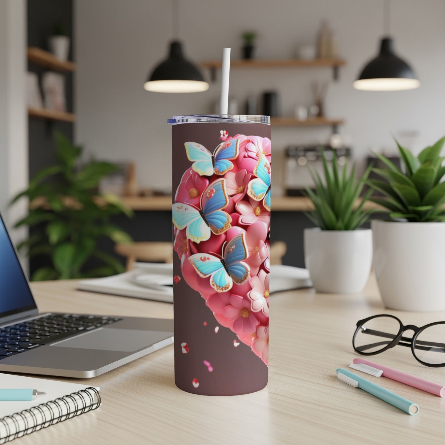 Heart-shaped tumbler with pink flowers and blue butterflies, white straw.