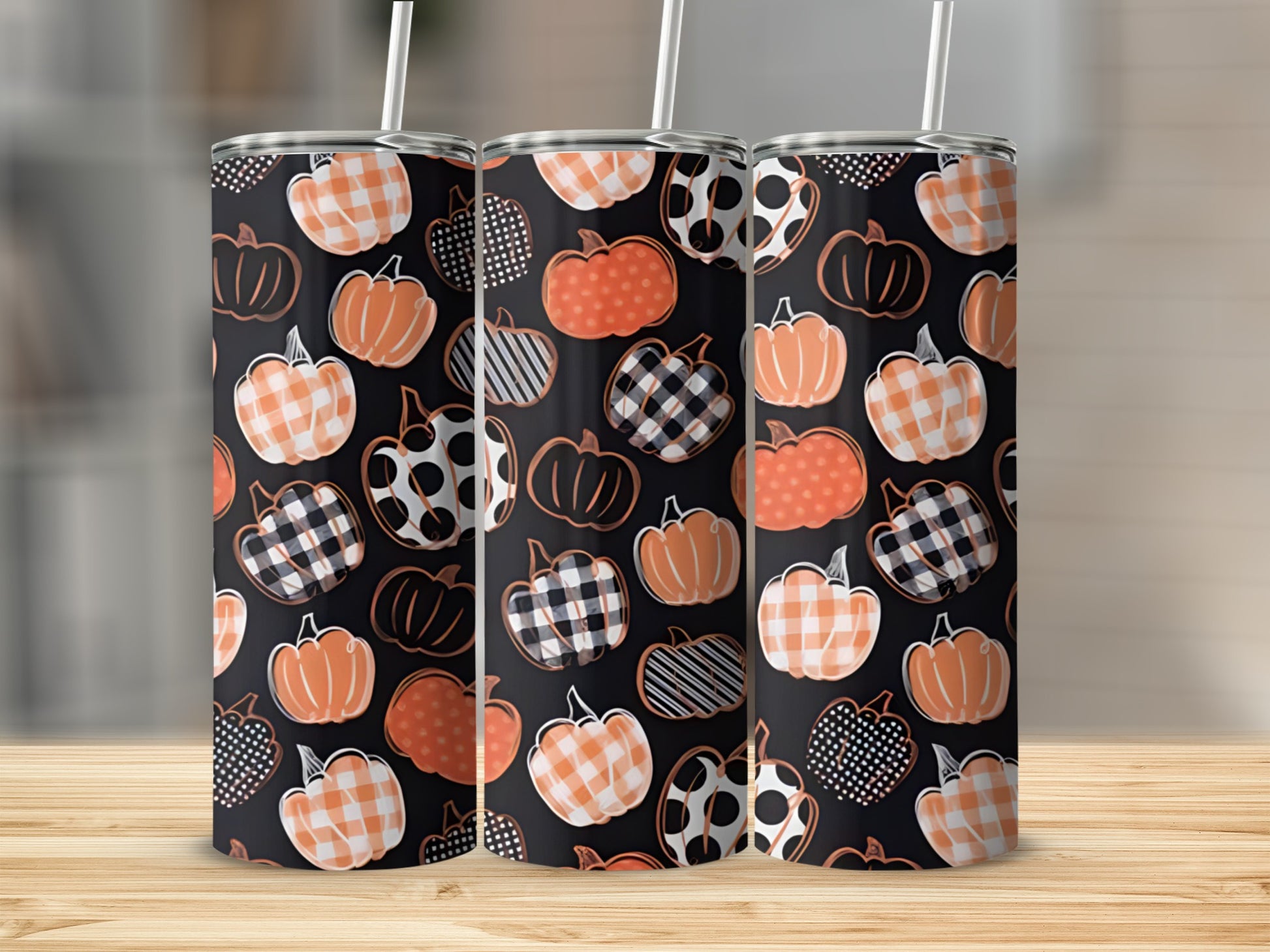 Three tumblers with orange, white, and black plaid pumpkin patterns.