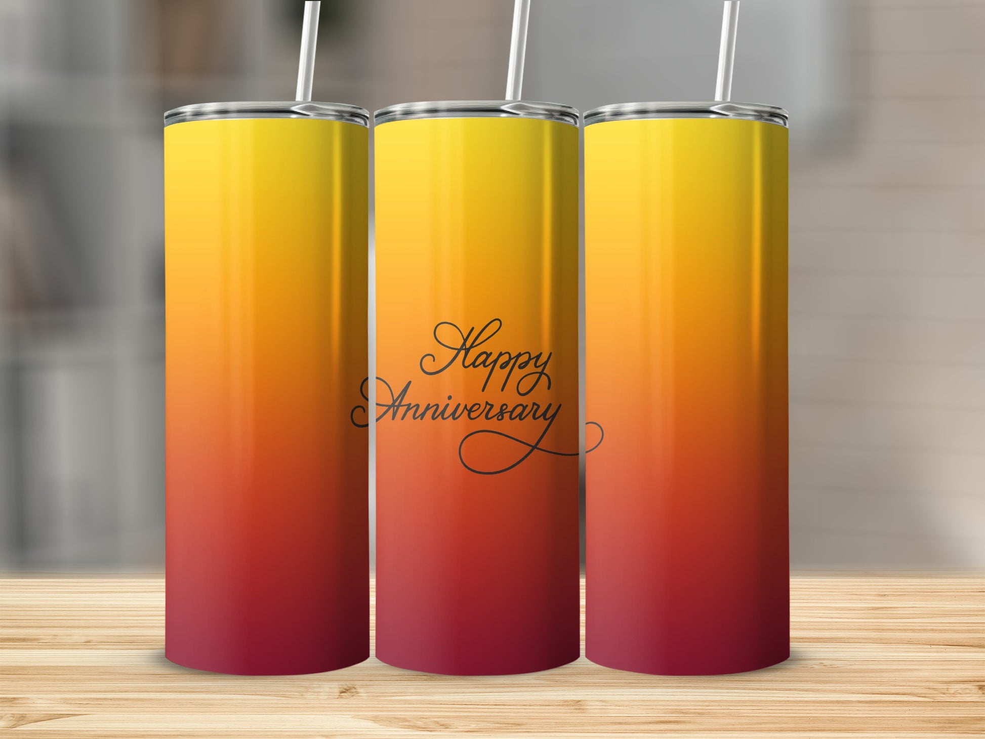 Three tall, insulated tumblers with a red to yellow gradient and "Happy Anniversary" text.