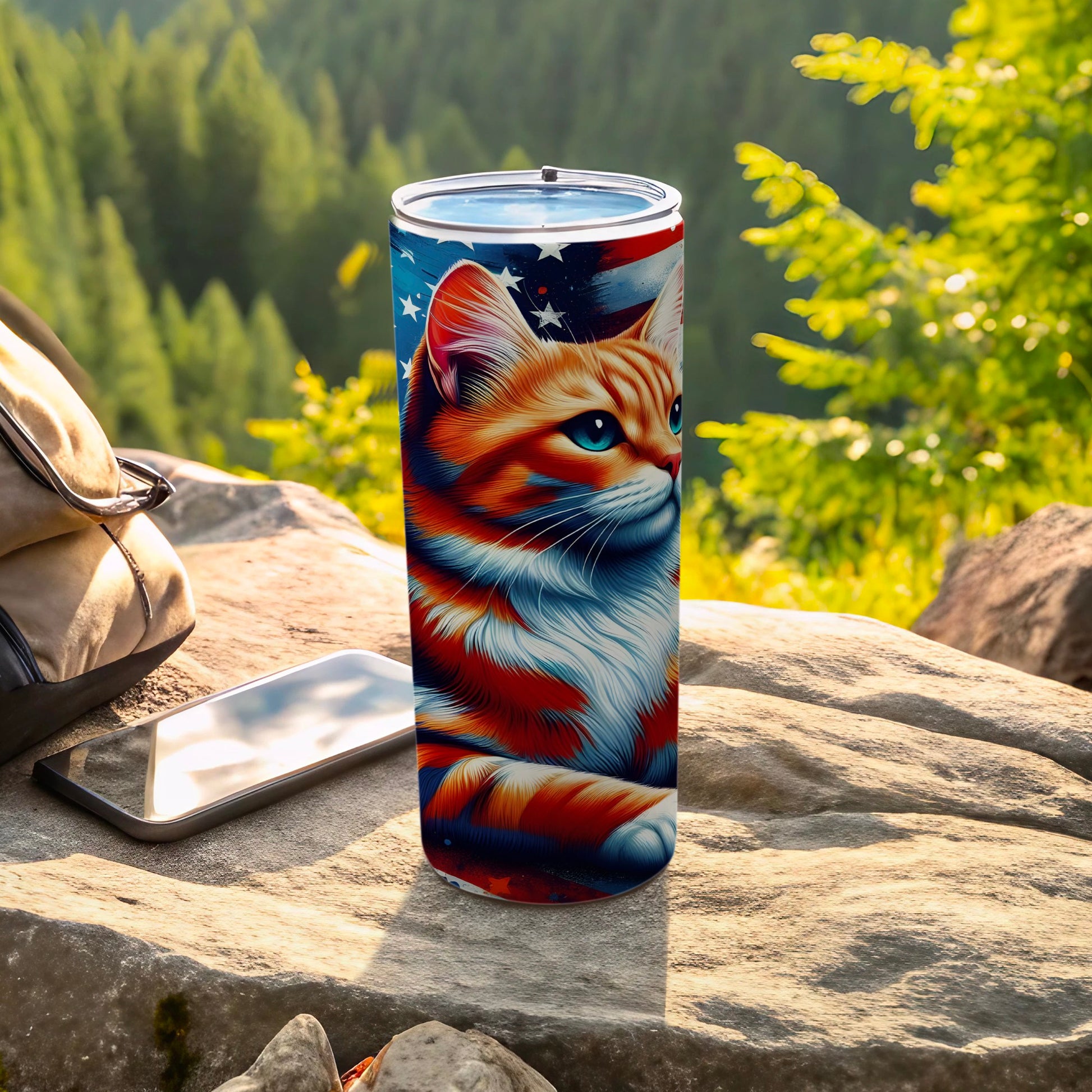 Orange tabby cat design on patriotic tumbler with forest background.