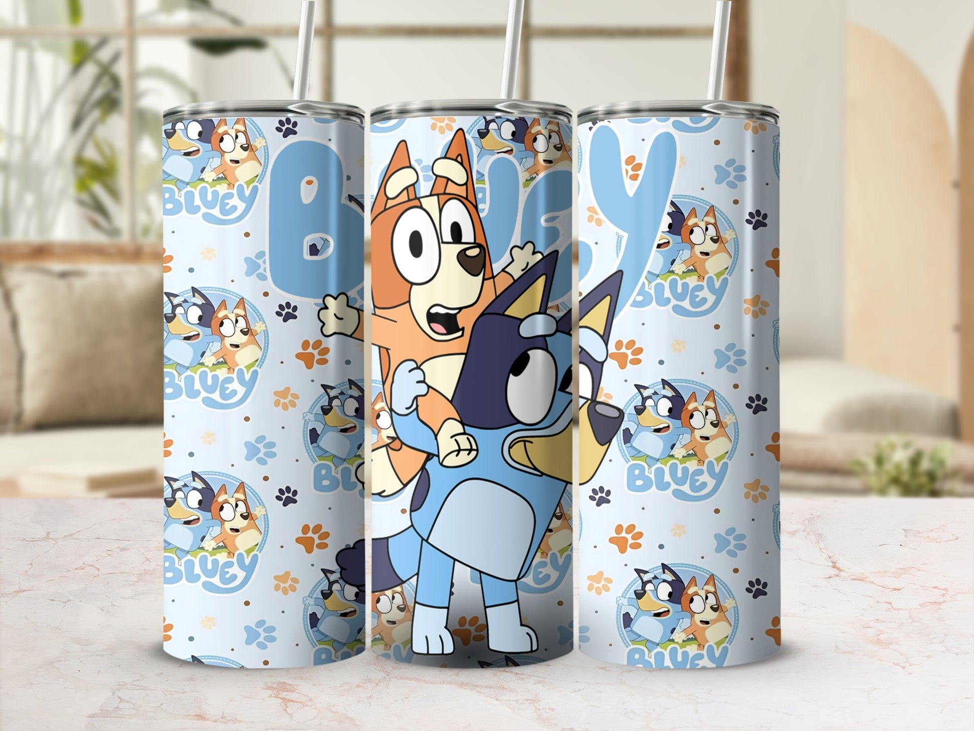 Bluey and Bingo characters on a light blue tumbler with a repeating paw print pattern.