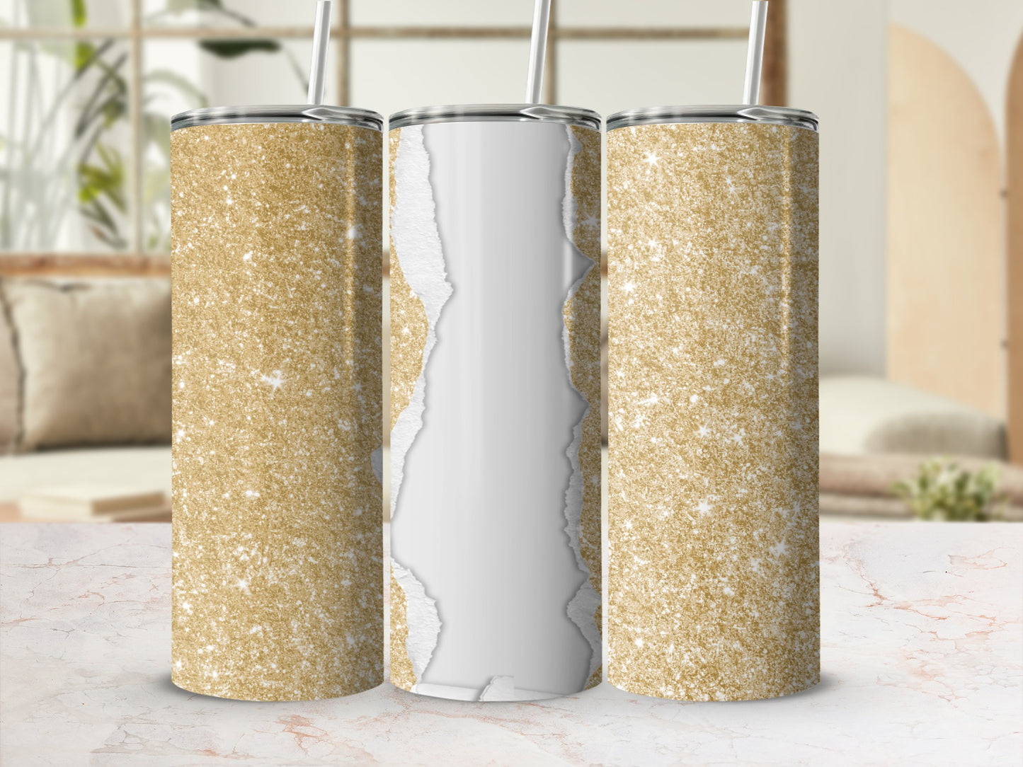 Three gold glitter tumblers with ripped paper effect on table.