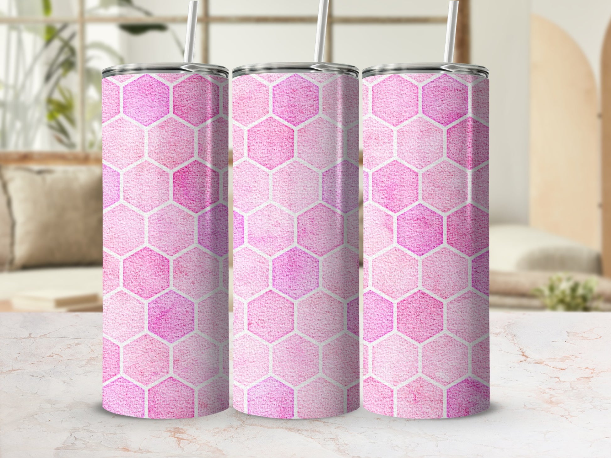 Three pink hexagon pattern tumblers with white straws, displayed in a row.