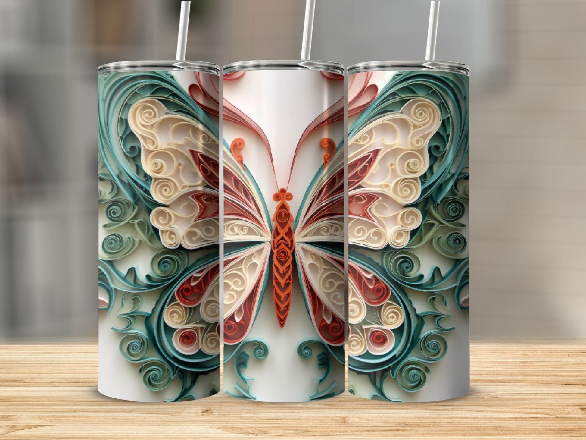 Three tumblers featuring a decorative butterfly design with red, cream, and teal colors.