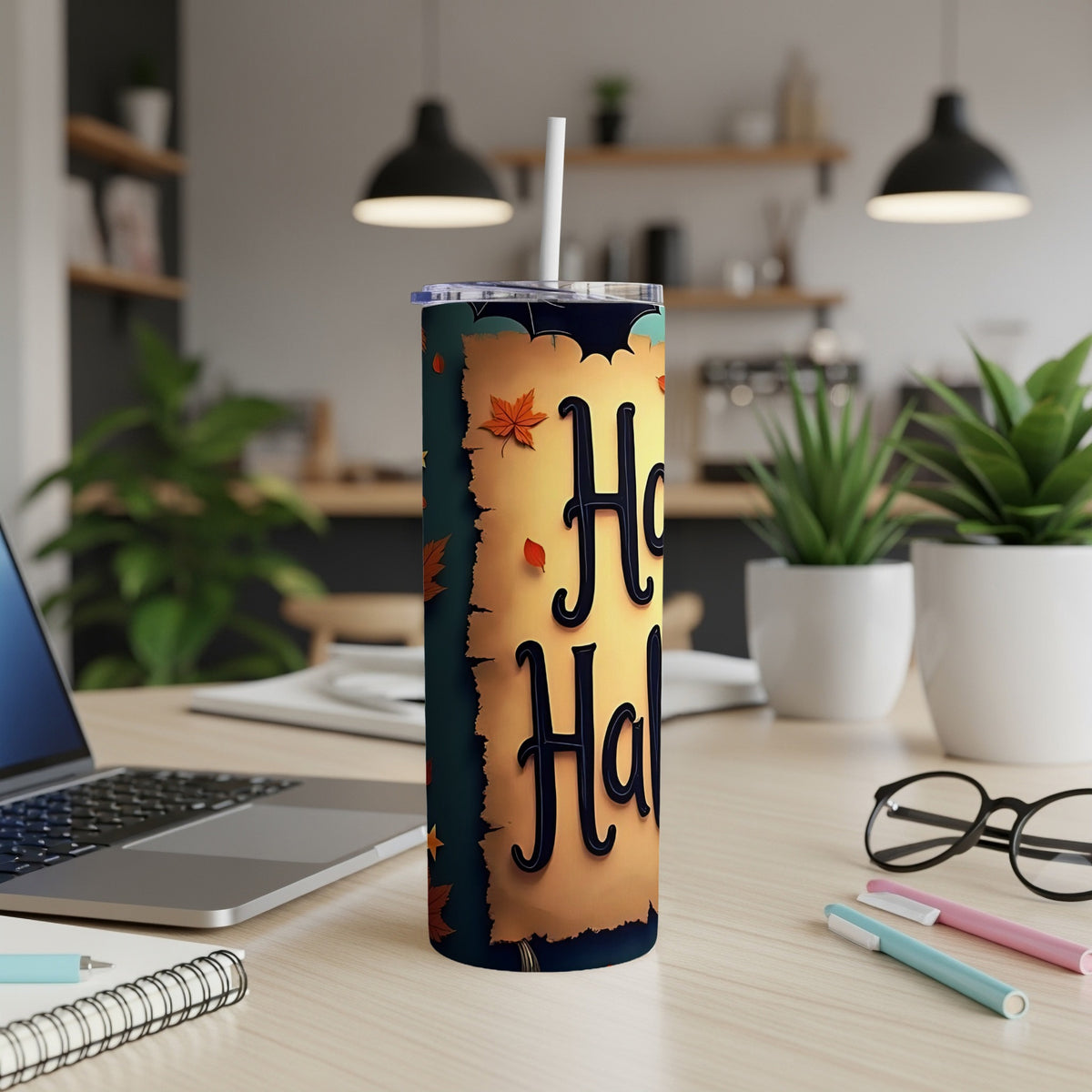 Tall tumbler with "Happy Halloween" text, bats, and fall leaves on a desk.