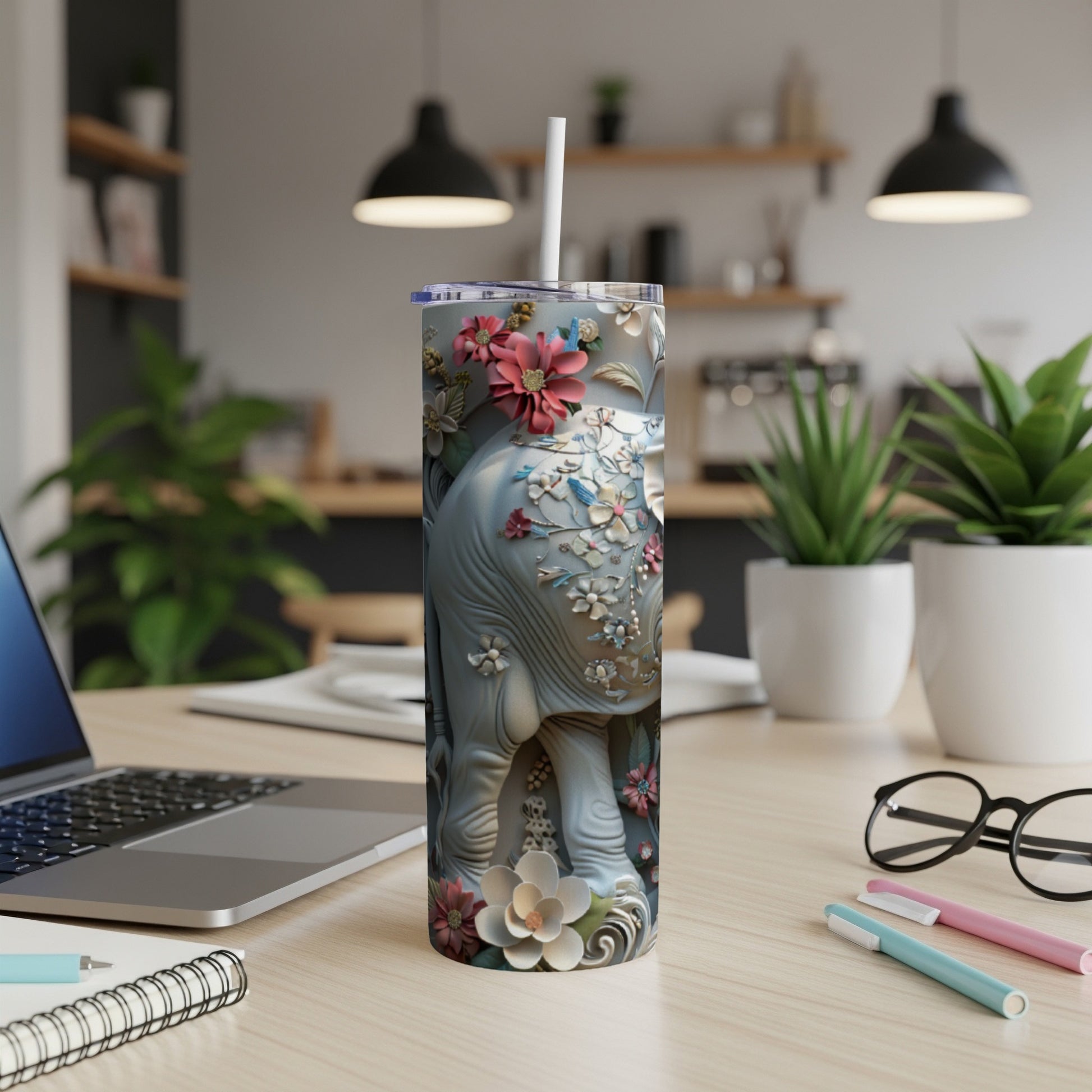 Gray elephant tumbler with floral design and white straw.