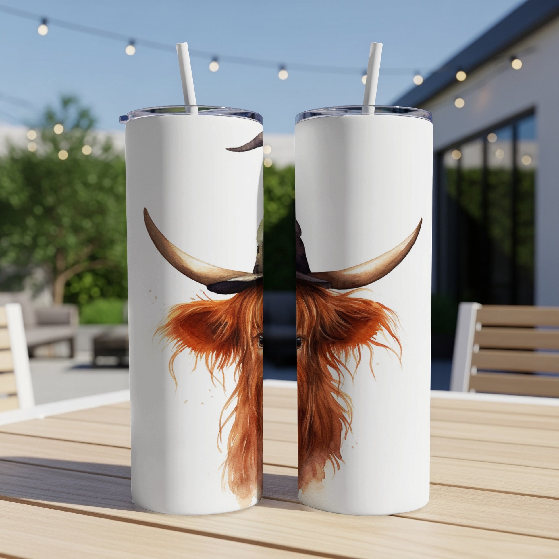 Two tumblers featuring a watercolor painting of a Highland cow with long horns.