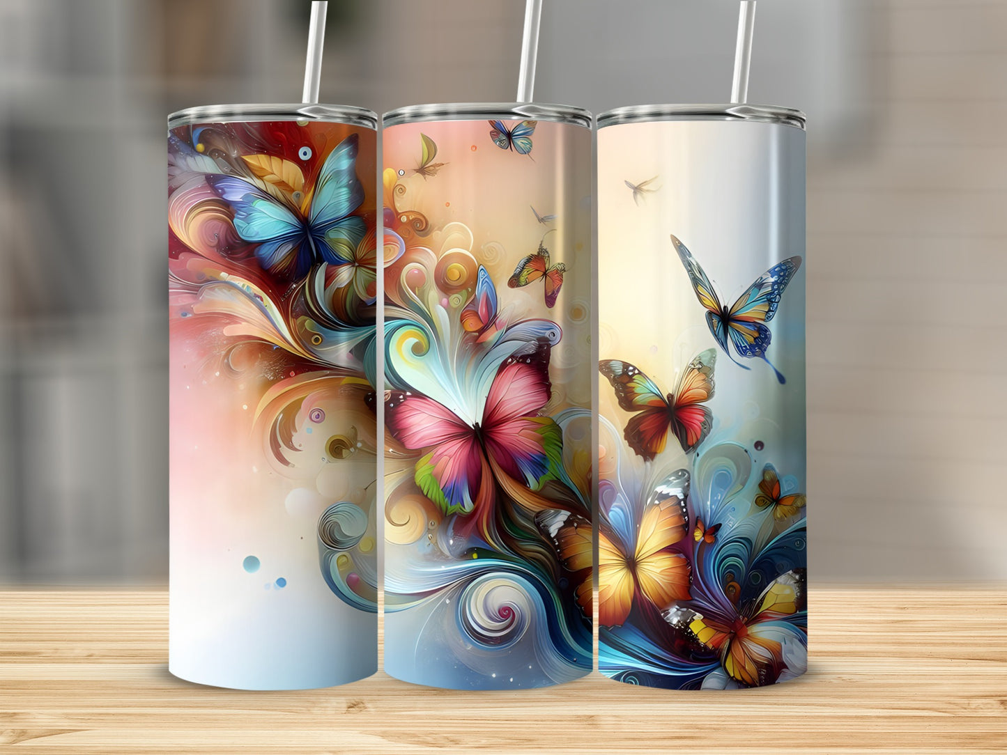 Three tall tumblers with colorful butterfly and floral designs.