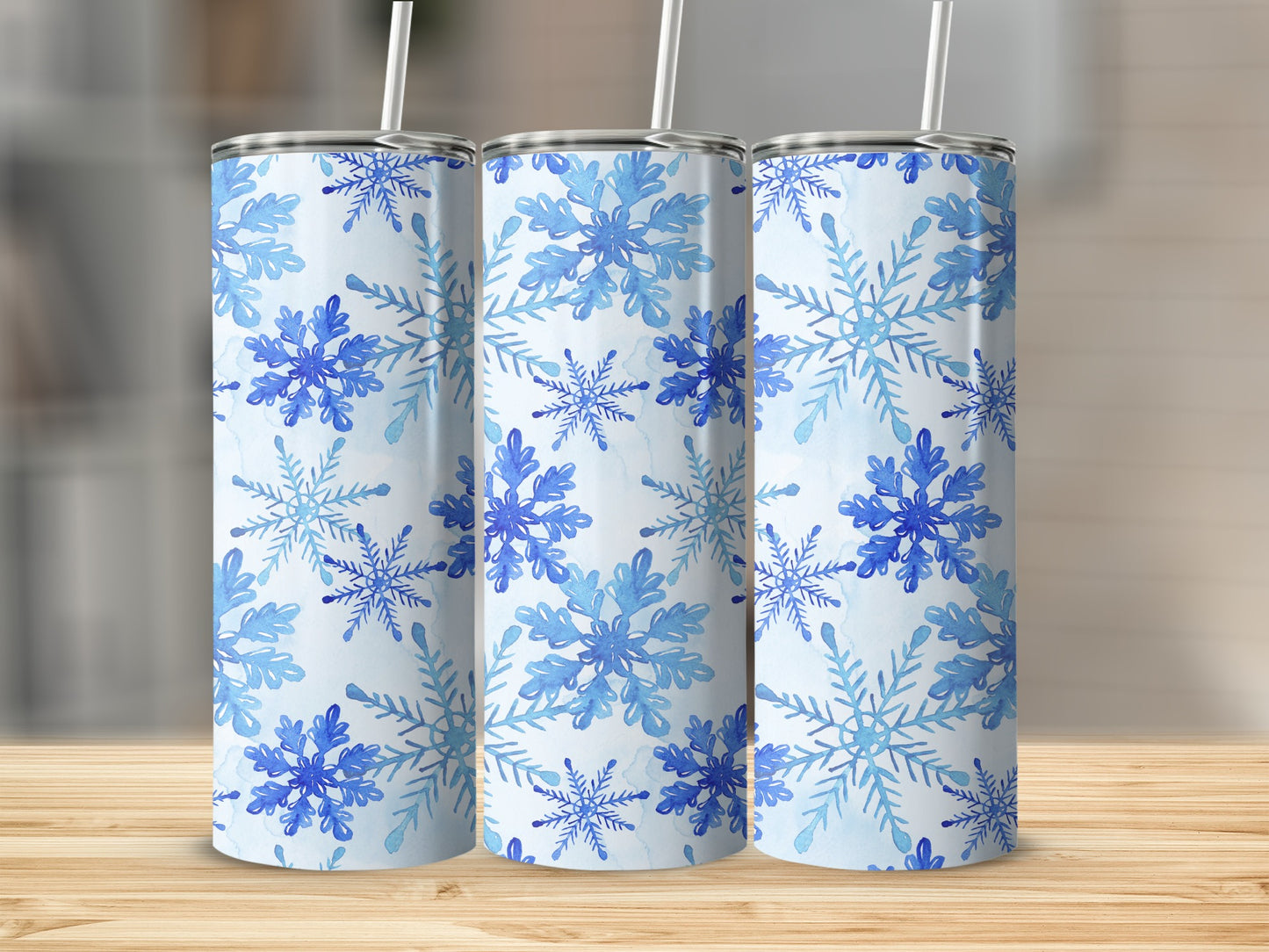 Three tumblers with a blue watercolor snowflake pattern.
