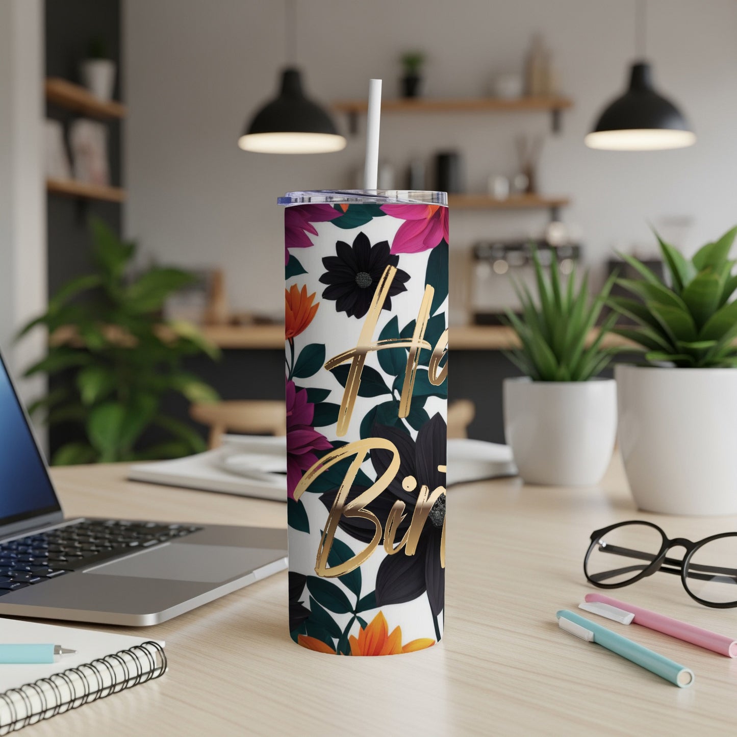 Floral tumbler with "Happy Birthday" text on a desk.