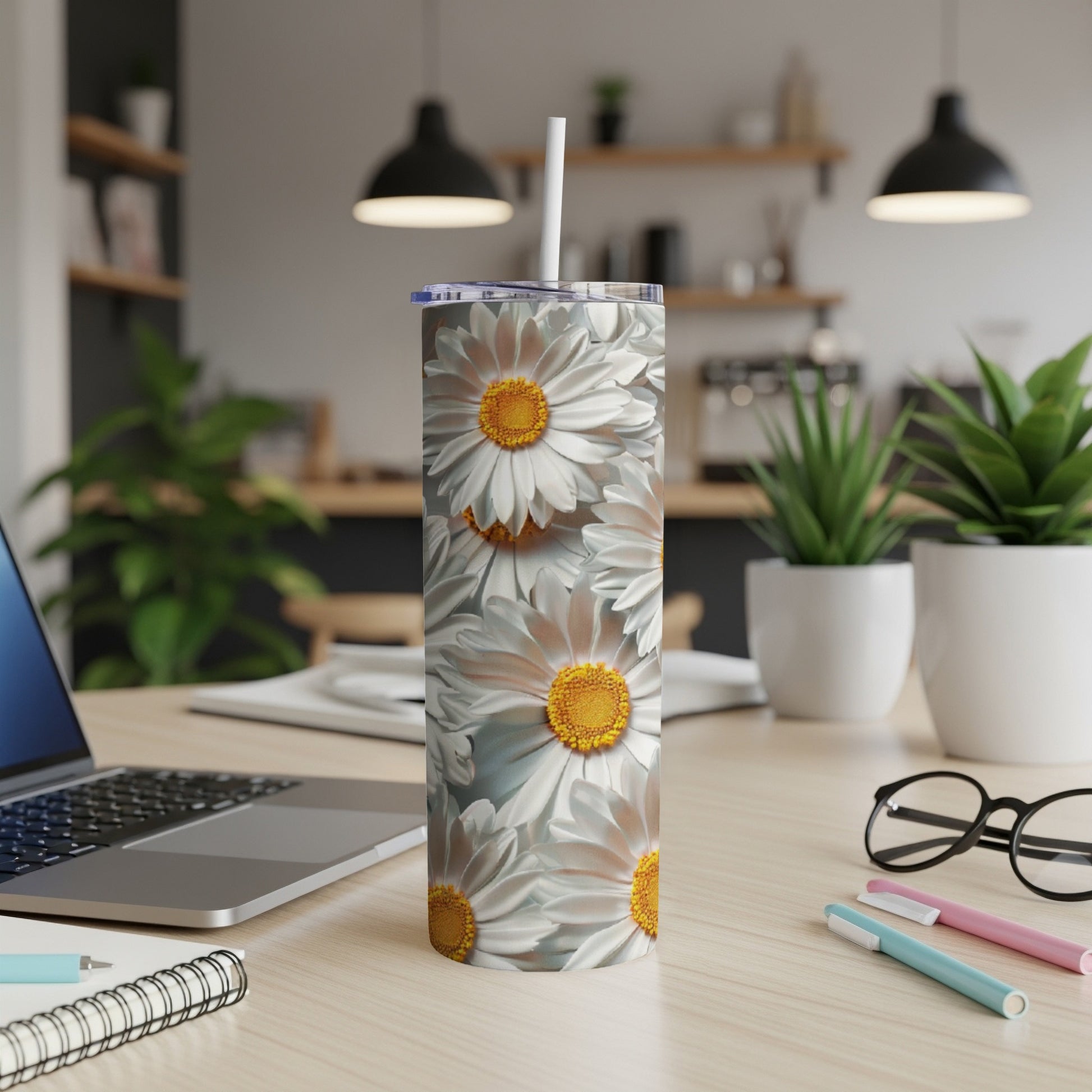 White daisies cover a white stainless steel tumbler with straw.
