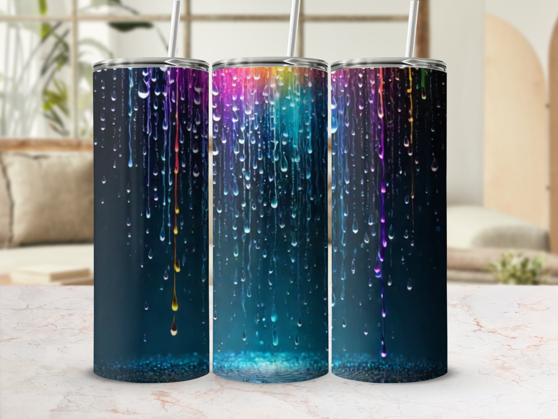 Three tumblers with colorful dripping paint design on dark background.
