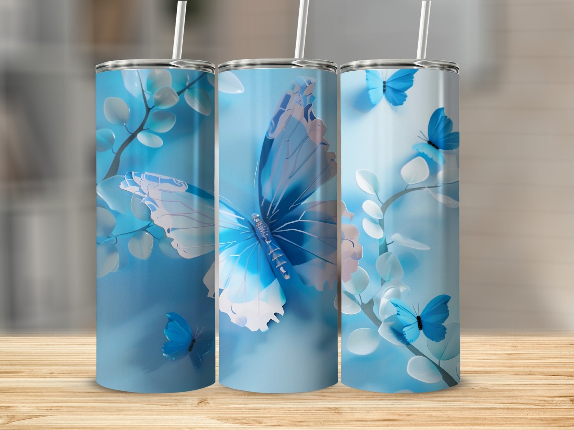 Three blue tumblers with a butterfly and floral design.