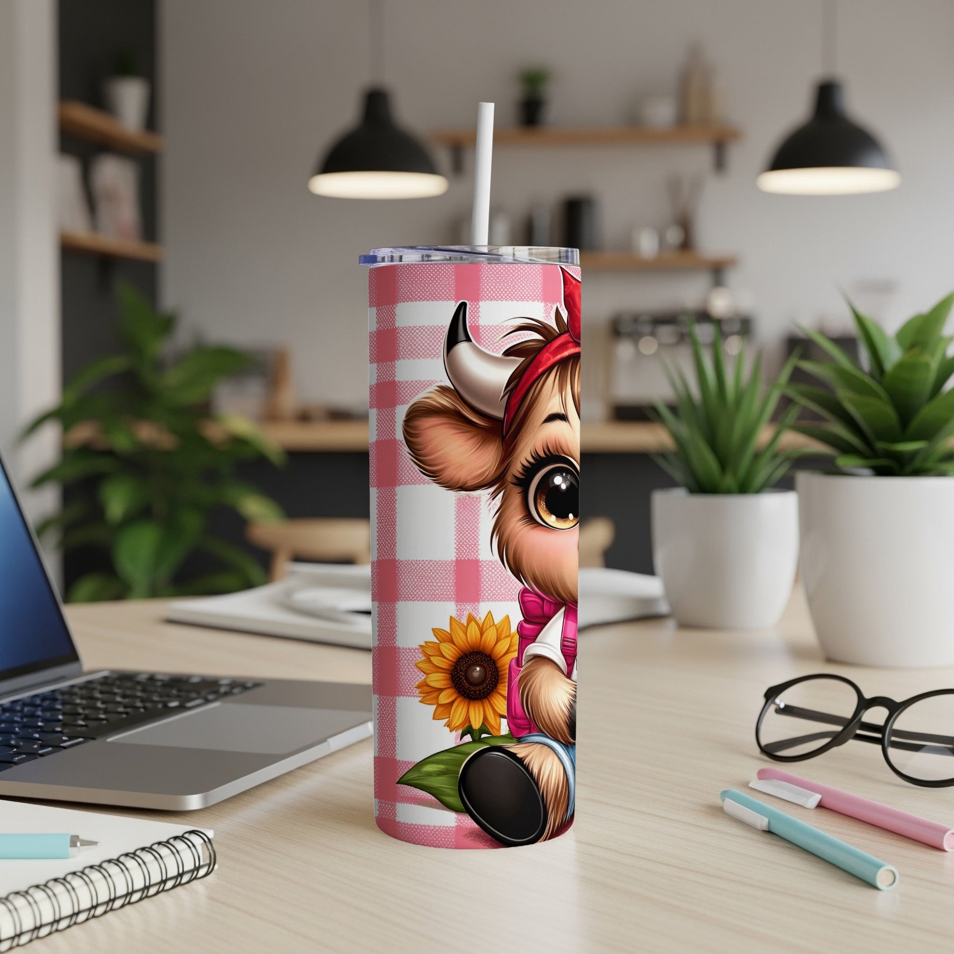 Cow illustration on a pink gingham tumbler with a sunflower and straw.