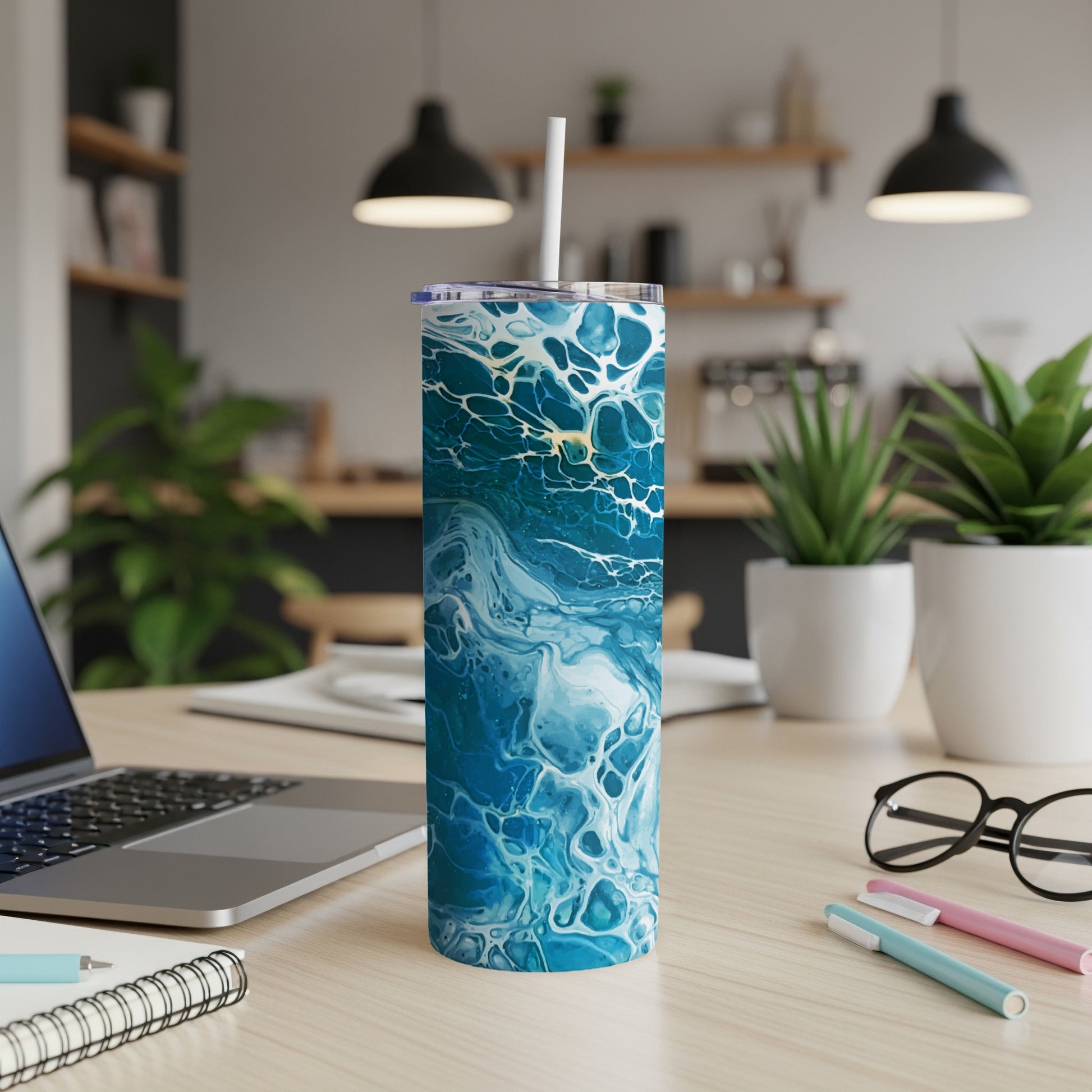 Tumbler with abstract blue and white wave pattern and white straw.