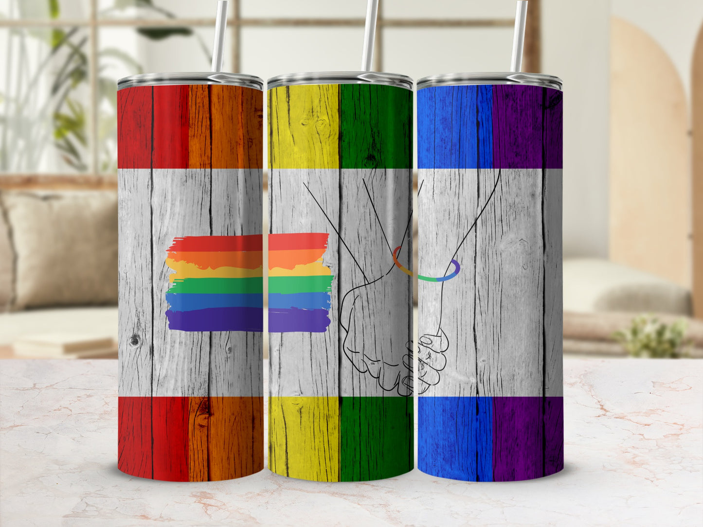 Three rainbow flag tumblers with clasped hands design.