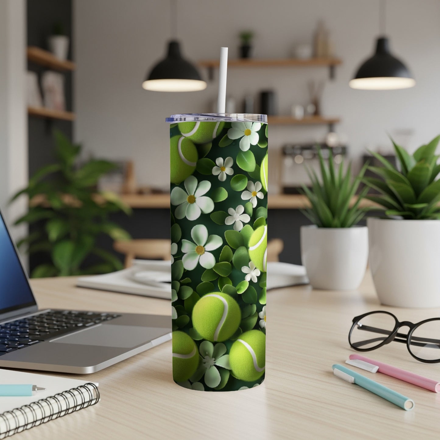 Green tennis balls and white flowers pattern on a white tumbler.