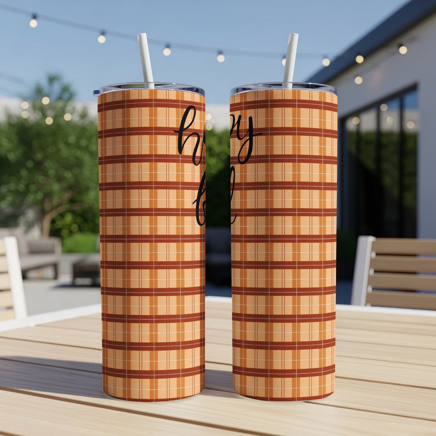 Two orange plaid tumblers with straws, featuring "happy fall" text.