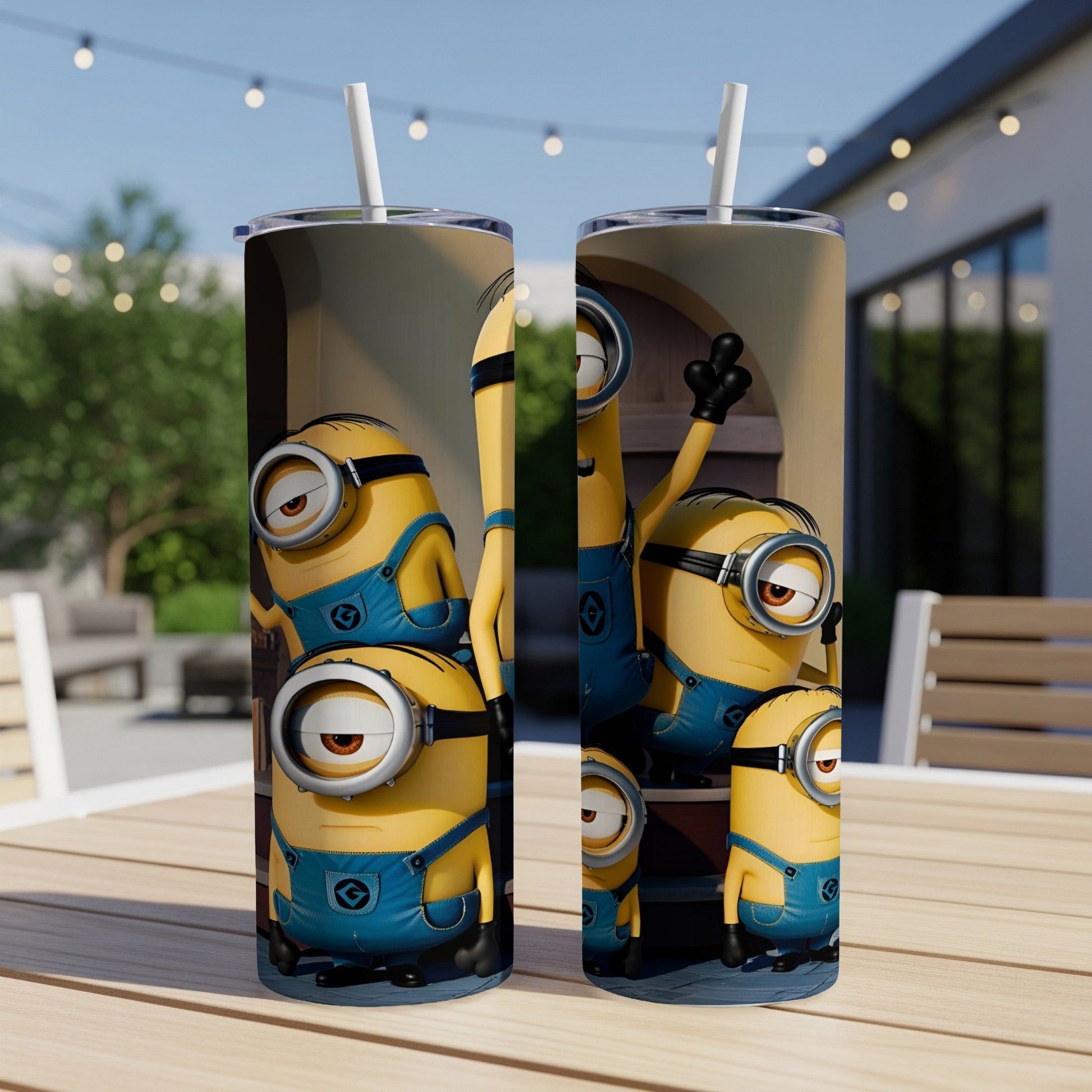Minions in blue overalls stand on a wooden table with a straw in each tumbler.
