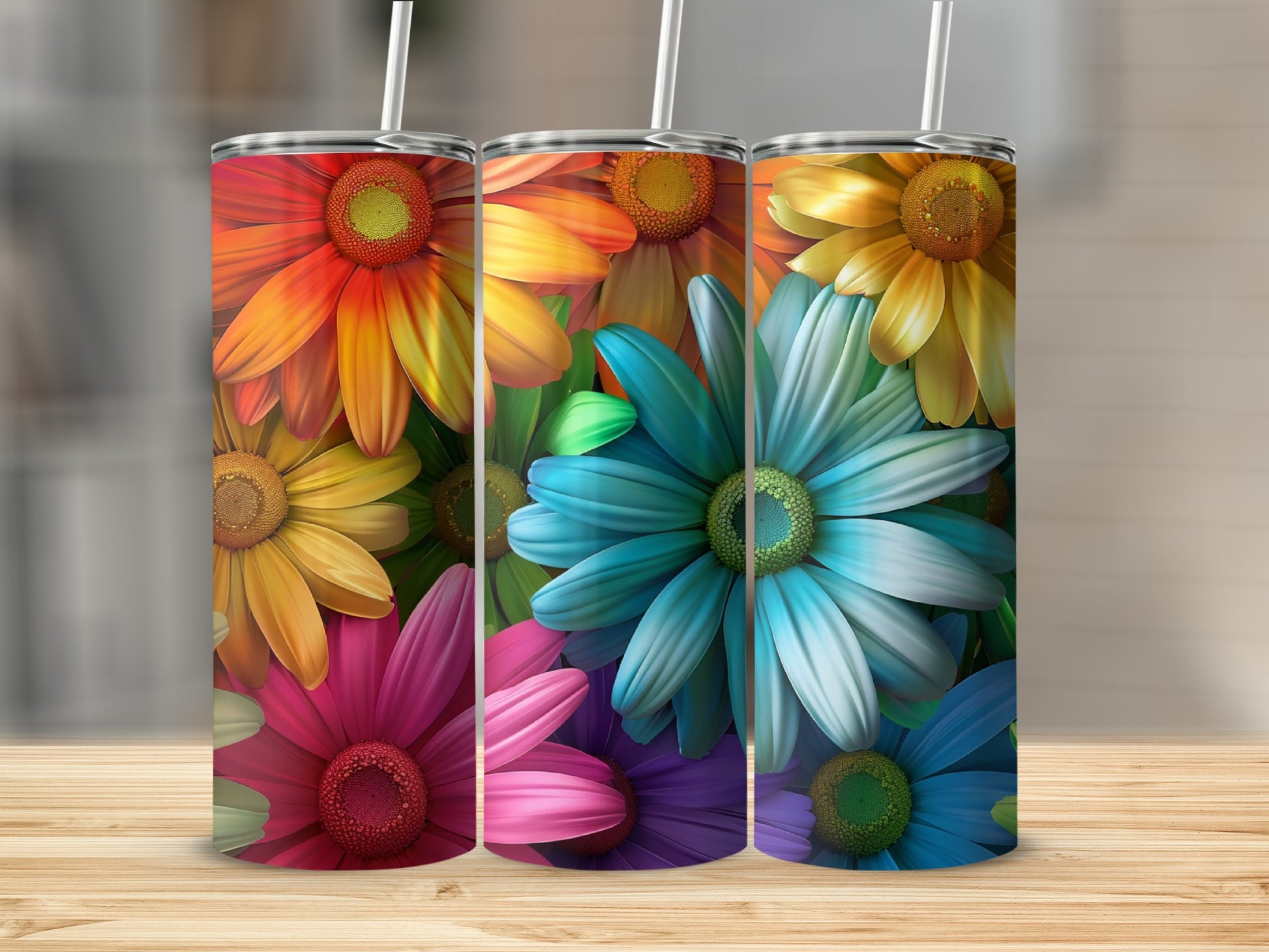Three tumblers with colorful daisy patterns on a wooden surface.