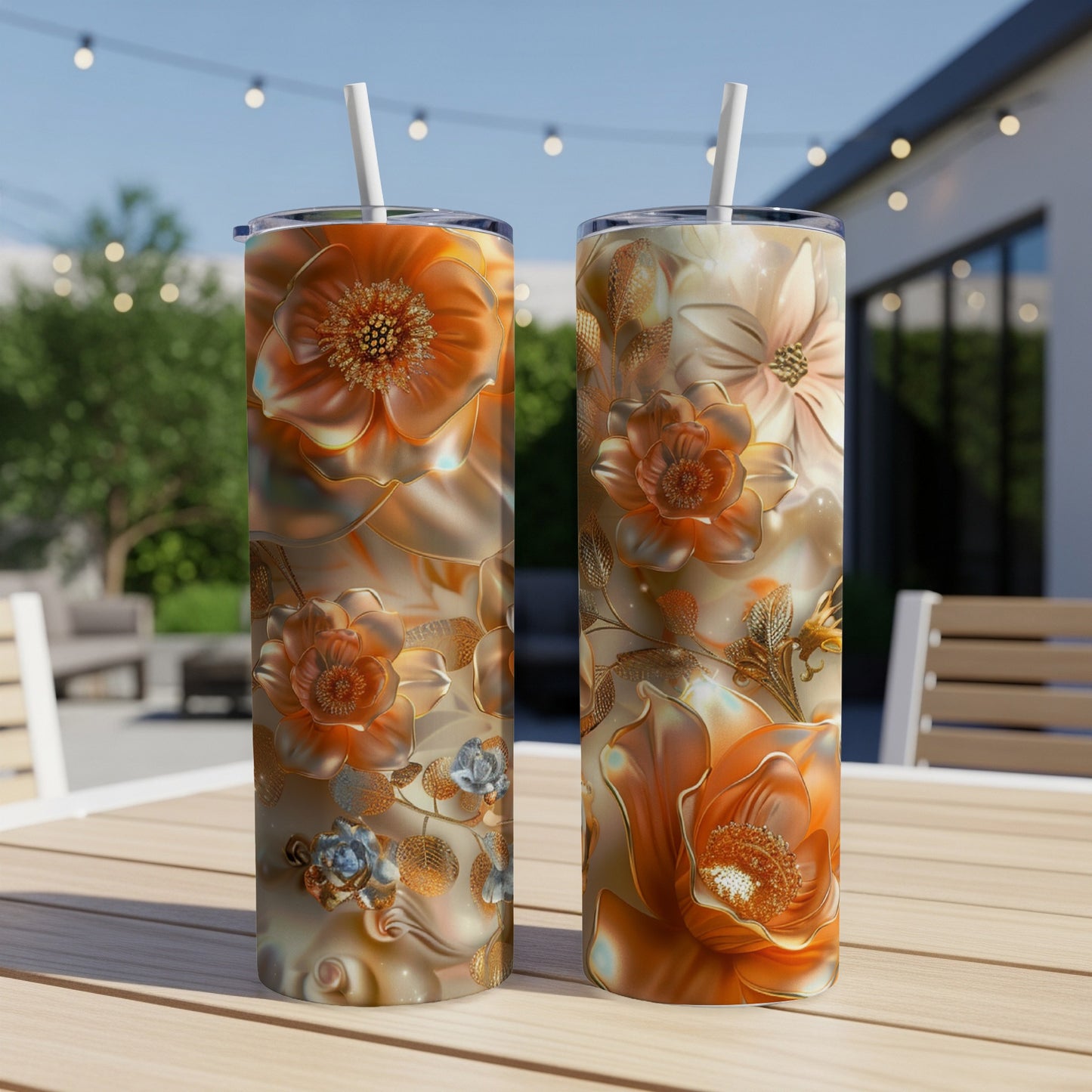 Two tumblers with floral design sit on a table outdoors.