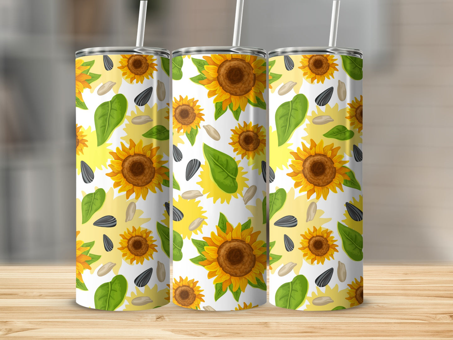 Three tumblers with a repeating sunflower and seed pattern.