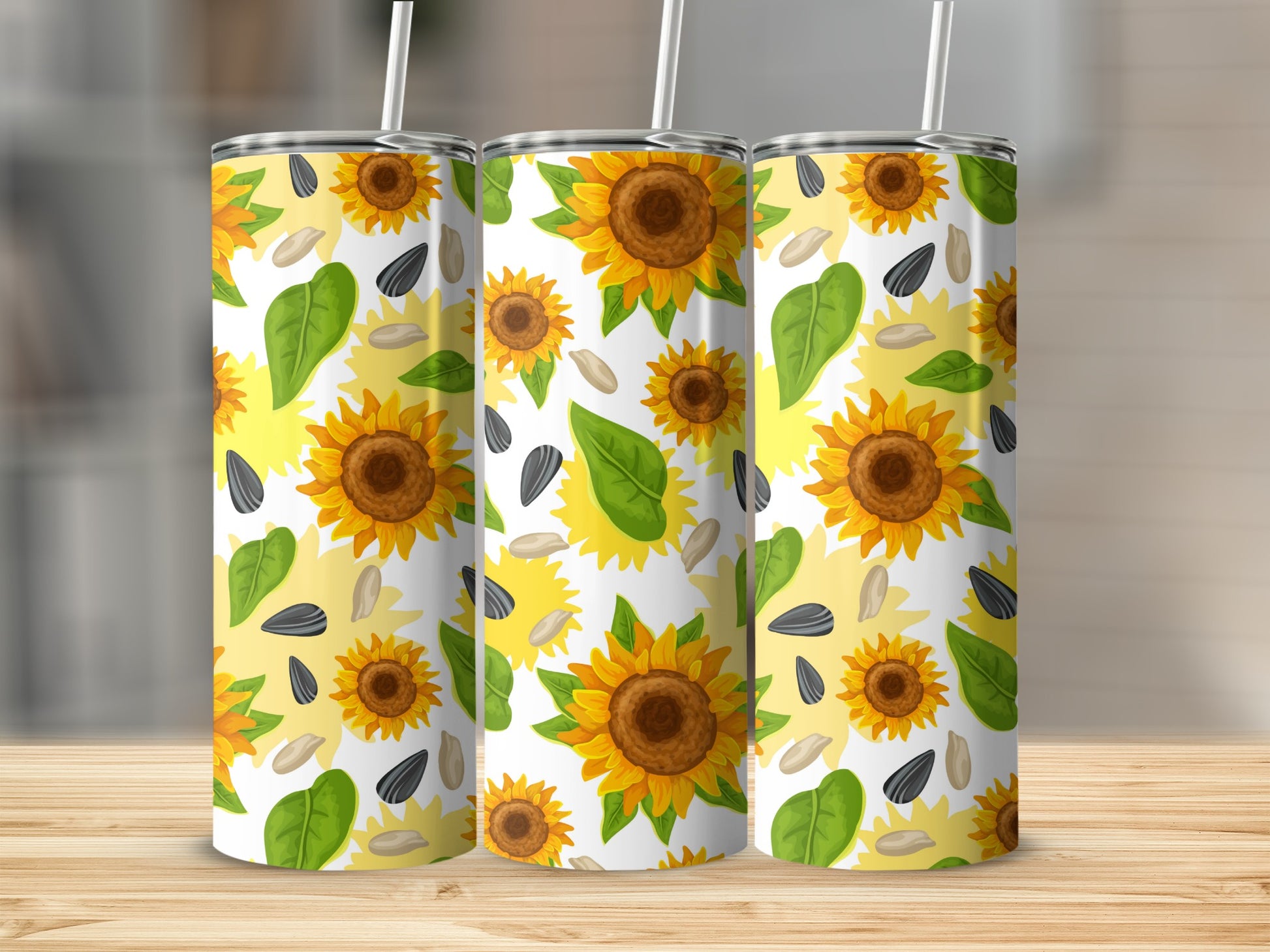 Three tumblers with a repeating sunflower and seed pattern.