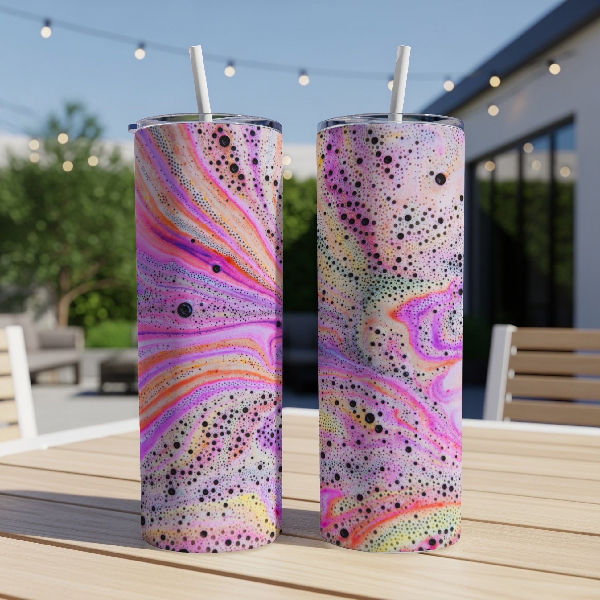 Two tumblers with colorful, marbled bubble patterns and straws.