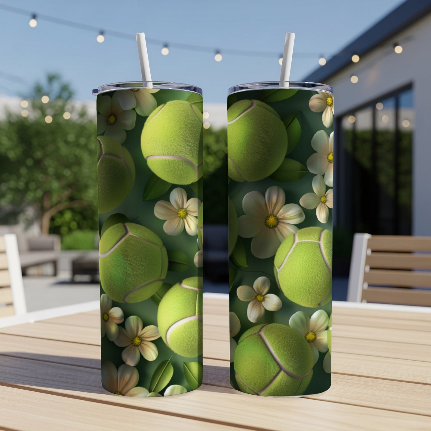 Two tumblers with a tennis ball and flower pattern on a table.