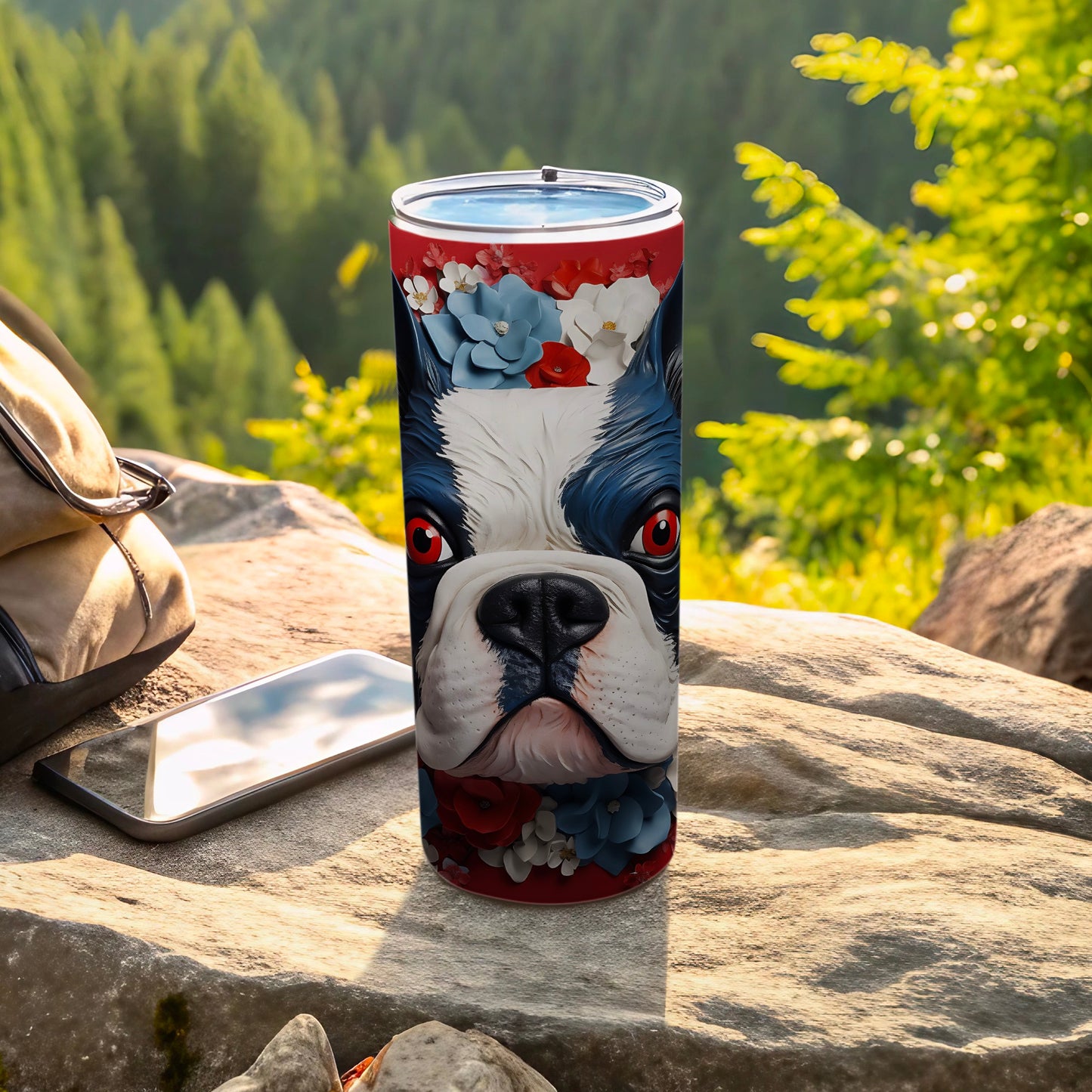 Boston Terrier head with floral accents on a skinny tumbler outdoors.