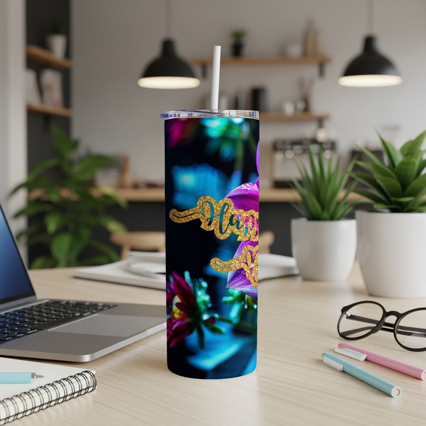 Tumbler with "Happy Holidays" text and floral design on desk.